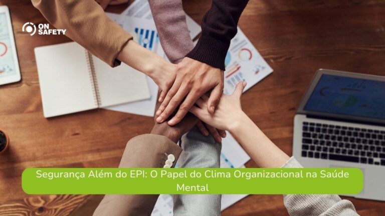 Texto alt: Mãos de diferentes pessoas se unindo em um gesto de colaboração sobre uma mesa de trabalho, que contém notebook, papéis com gráficos e um caderno. No canto superior esquerdo, o logo da OnSafety. Na parte inferior da imagem, uma faixa verde contém o texto: "Segurança Além do EPI: O Papel do Clima Organizacional na Saúde Mental".