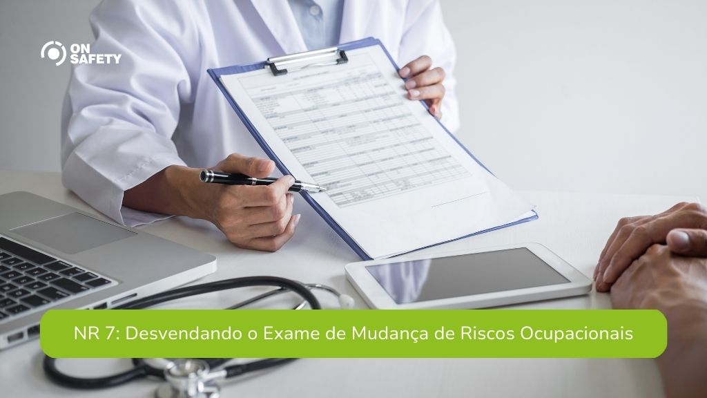 Close-up de um médico de jaleco branco, segurando uma prancheta com um formulário e apontando para ele com uma caneta, enquanto se dirige a um paciente. Sobre a mesa, há um laptop, um estetoscópio e um tablet. Na parte inferior, uma faixa verde com o texto "NR 7: Desvendando o Exame de Mudança de Riscos Ocupacionais".